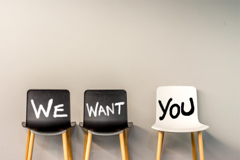 Three chairs with the words 'We', 'Want', and 'You' written on them