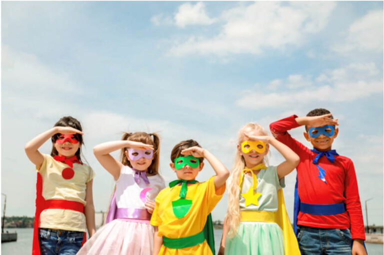 Five children dressed as superheroes
