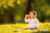 A child drinking from a cup on a sunny day