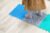 A child walking across linked textured mats - the first is bobbly, the second is pebbly and the third is prickly