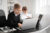 Two children at a desk looking like businesspeople