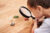 A child with a magnifying glass looking at fake insects