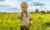 A child holding flowers in a field, in touch with their emotional development