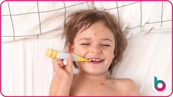 Smiling child with spots taking temperature as you might for hand, foot and mouth