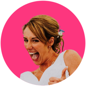 A headshot of a woman doing a thumbs up wearing a wedding dress