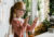 Girl with magnifying glass inspecting papercraft beetle