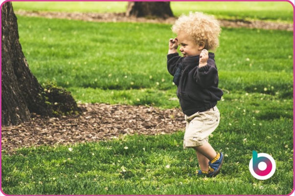 A child running happily in the grass