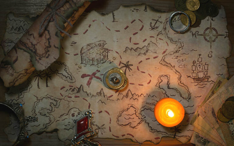 A faded and worn treasure map lit by candlelight