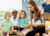 A woman reading a story to a group of children