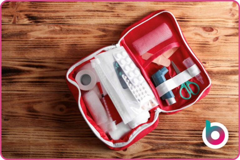 a first aid kit with pills, tape, gauze, a syringe, an inhaler and other first aid bits and pieces