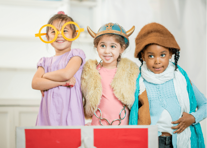 Children playing dress up for workd book day - a viking, someone with big glasses and Elsa from frozen with a hat