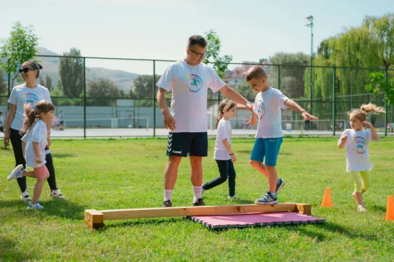 Children running an obstacle course over a balance beam
