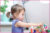 Child playing with paper rings and glue sticks