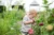 Bee Activities Image - Child in an allotment sniffing flowers