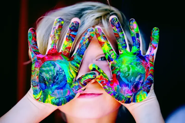 Elmer activities image - a child with hands covered in mixed paint