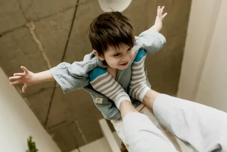 Child flying on adult's upturned feet