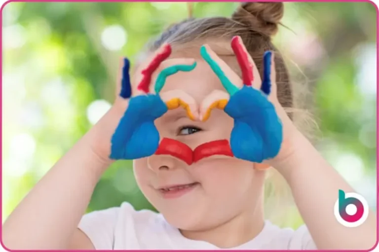 Child looking through heart hands