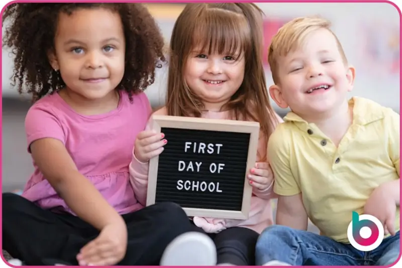 School readiness image - children holding up a board saying First Day of School
