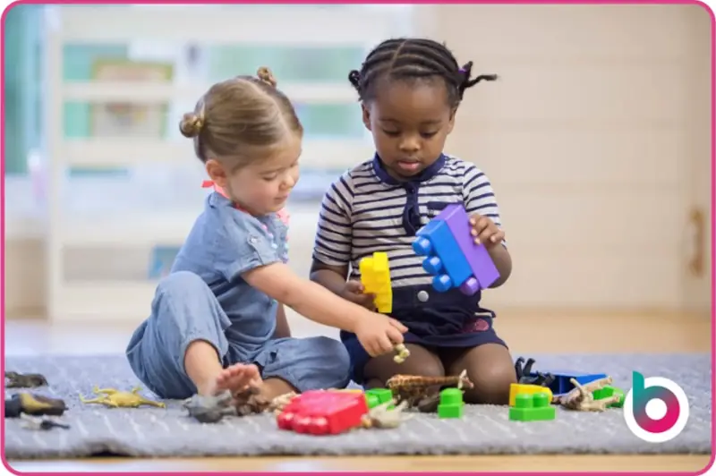 Mutual Respect image - Two children playing together with coloured plastic blocks