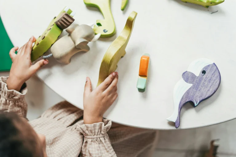 Child playing with animal toys