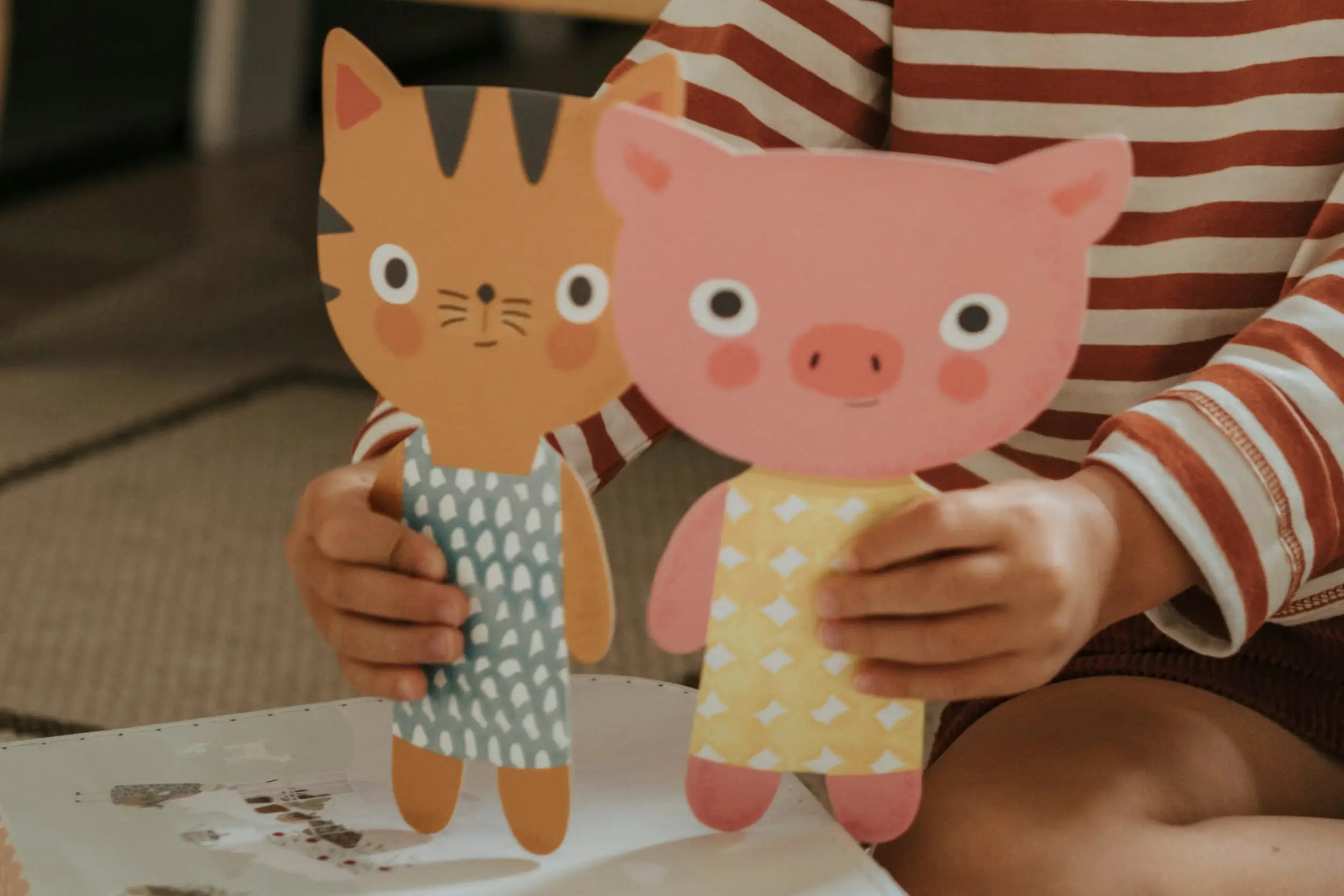 Girl playing with animal cutouts