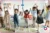 a group of children stepping forward with arms raised in a nursery