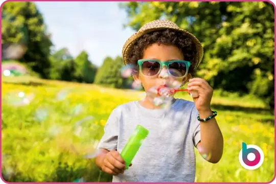 a child blowing bubbles