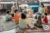 Two adults and several children sat in a circle