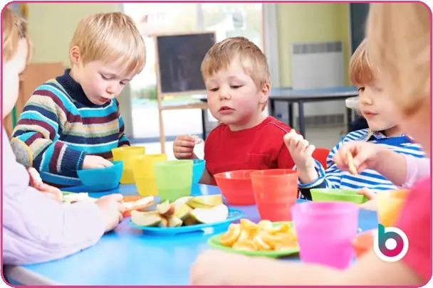 Children eating round a table