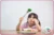 Child with broccoli, looking somewhat disappointed