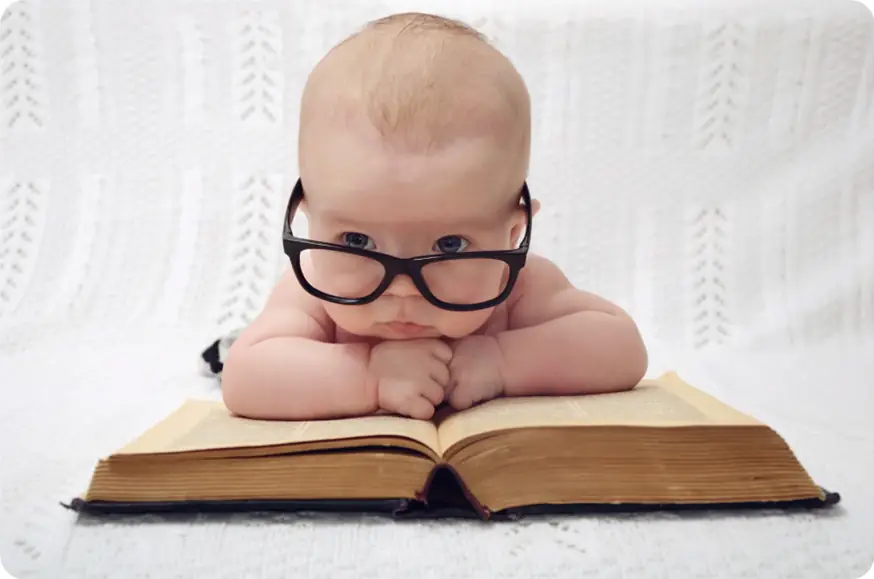 The Day of nursery inspection image - a baby on a book with glasses