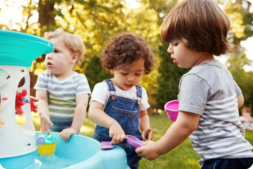 The Day of nursery inspection image - children playing on an outdoor water table